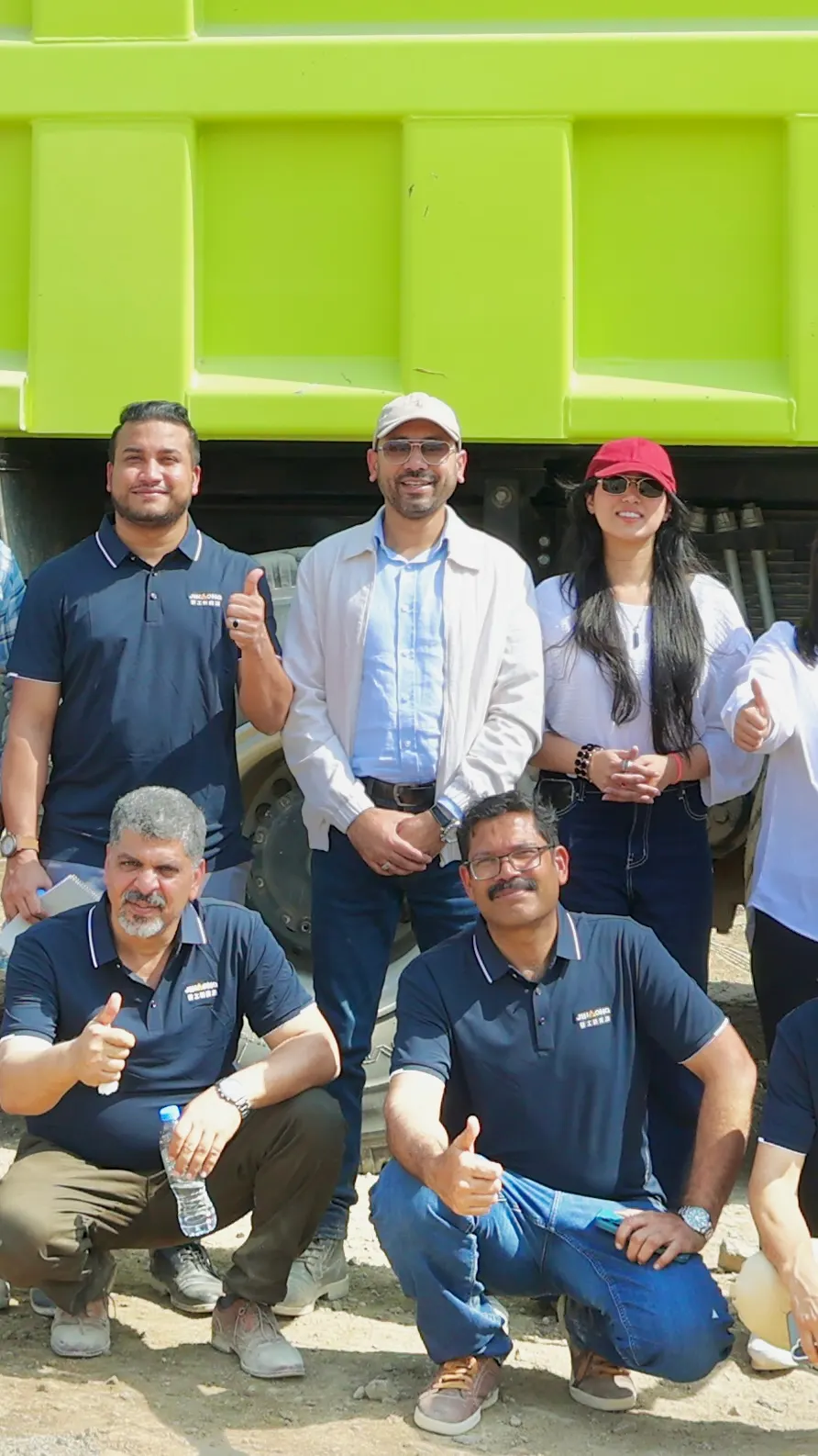 Jingong and Lootah Group team at the EV heavy machinery launch with the green dump truck