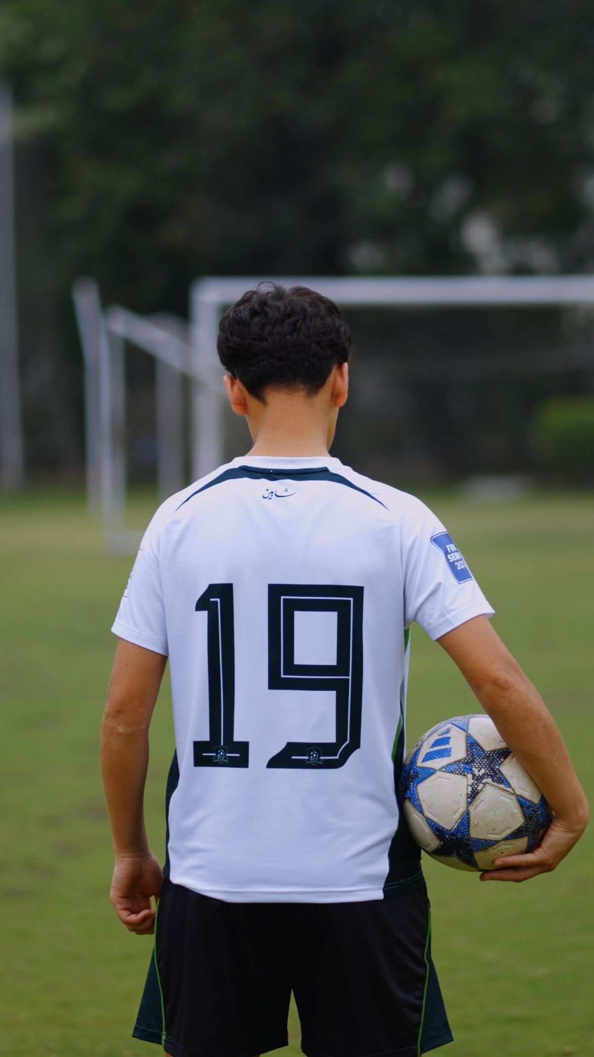 Pakistan Football Federation player number 19 seen from behind